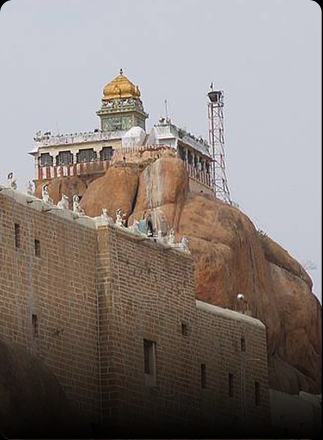 A view of the Namakkal hill temple featuring stone steps and ancient architecture in bright daylight.