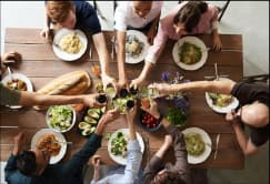 Group enjoying a shared meal arranged as part of coordinated events for teams and large groups.