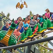 Group of people riding a colorful mid thrill attraction suitable for families and all age groups.
